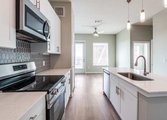 A kitchen with a stove top oven and a microwave.