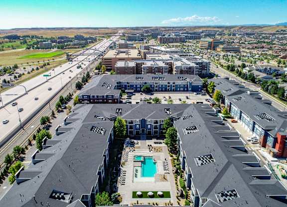an aerial view of a city with buildings and a pool