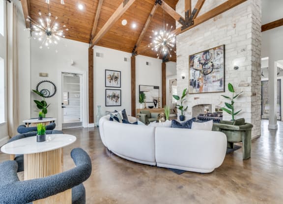 a living room with couches and chairs and a fireplace