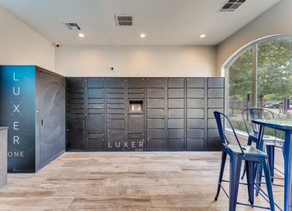 a bar with blue stools in front of a large metal locker door