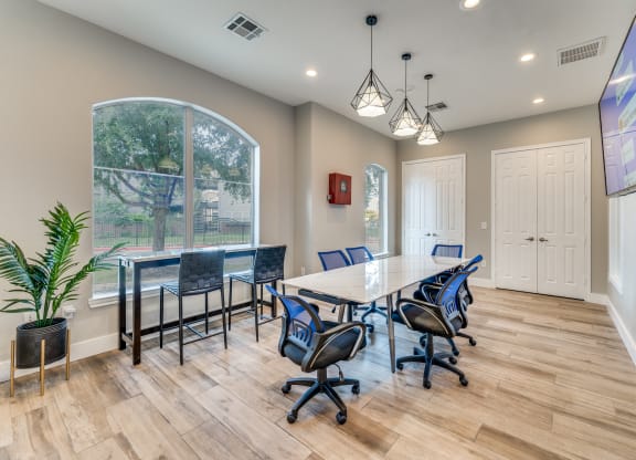 a conference room with a table and chairs and a large window