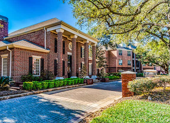 A red brick building with a white door and windows.