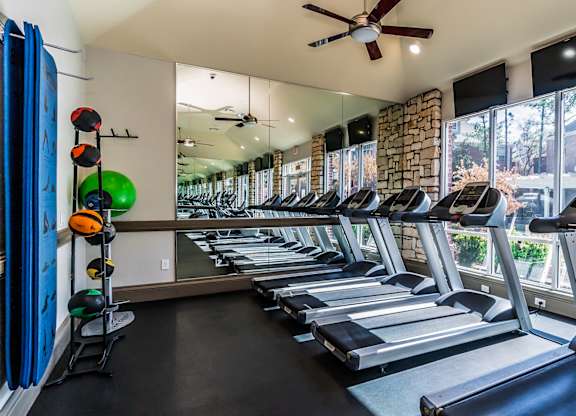 A gym with treadmills and exercise equipment.