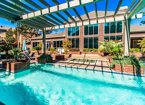 A swimming pool under a covered patio area.