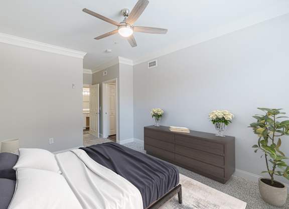 a bedroom with a bed and a ceiling fan