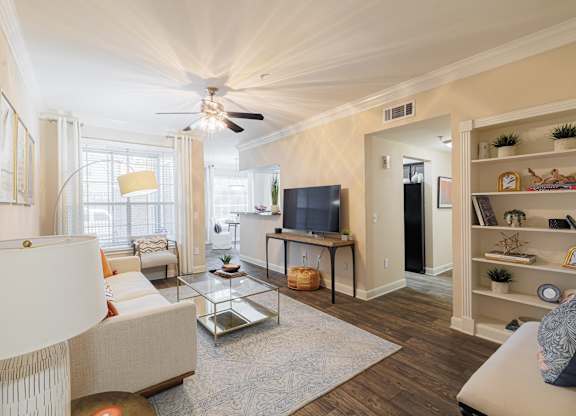 A living room with a white couch and a television.
