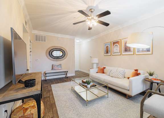 A living room with a white couch and a coffee table.