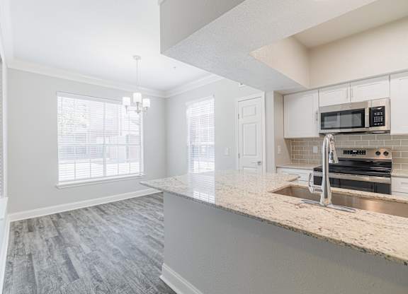a kitchen with a marble counter top and a sink