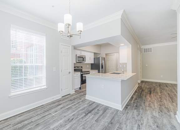 an open kitchen and living room with a large window