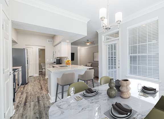 an open kitchen and dining room with a marble table and chairs