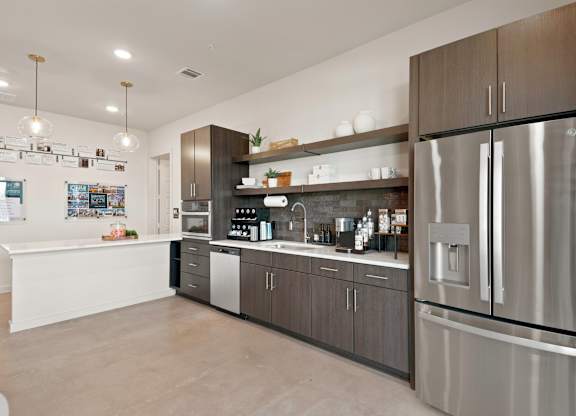 A modern kitchen with a stainless steel refrigerator and wooden cabinets.