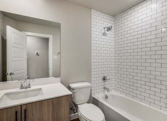 A white bathroom with a sink, toilet, and bathtub.