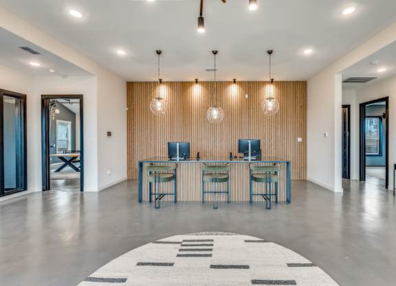 A modern room with a long table and chairs.