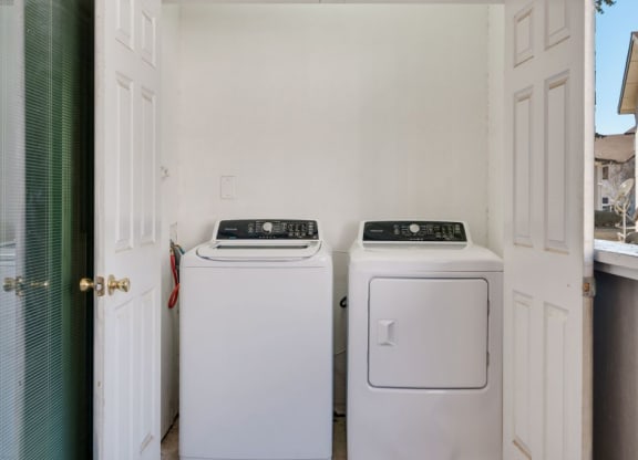 a washer and dryer in a laundry room with a door