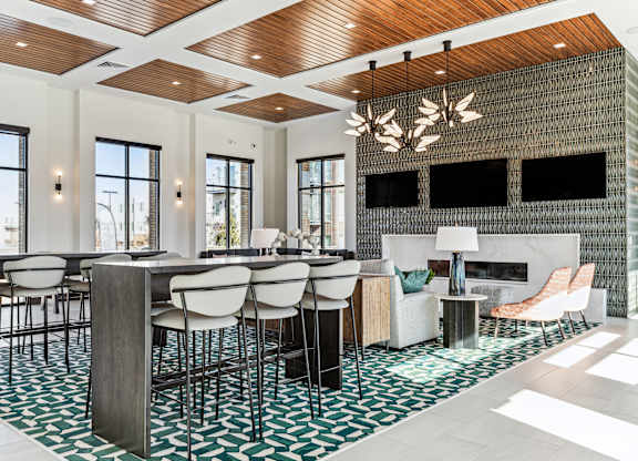 A modern dining room with a wooden ceiling and a fireplace.