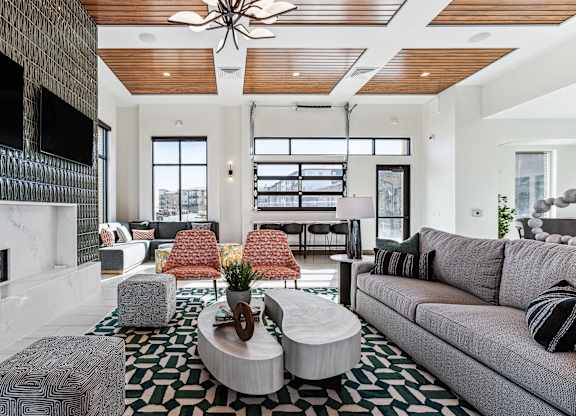 A modern living room with a fireplace and a large couch.