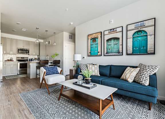A living room with a blue couch and a coffee table.