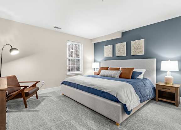 a bedroom with a bed and a desk with a chair