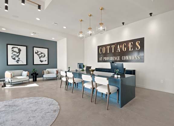 A room with a sign that says "Cottages at Providence Commons" on the wall.