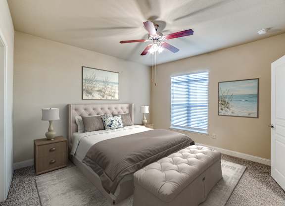 A bedroom with a large bed, a ceiling fan, and two pictures on the wall.
