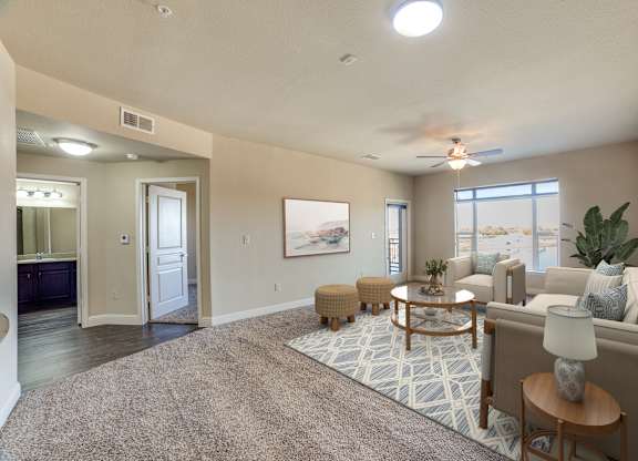 A well-lit living room with a rug, a sofa, and a coffee table.