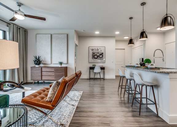 A modern kitchen with a bar area and a dining table.