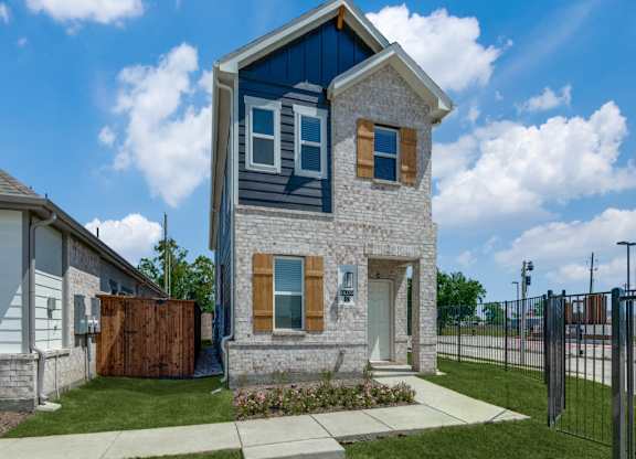 A blue house with a white door and windows.