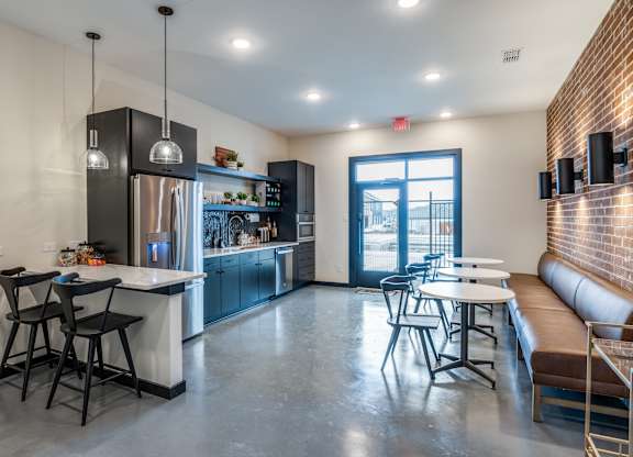 A modern kitchen with a dining area and a view of the outdoors.