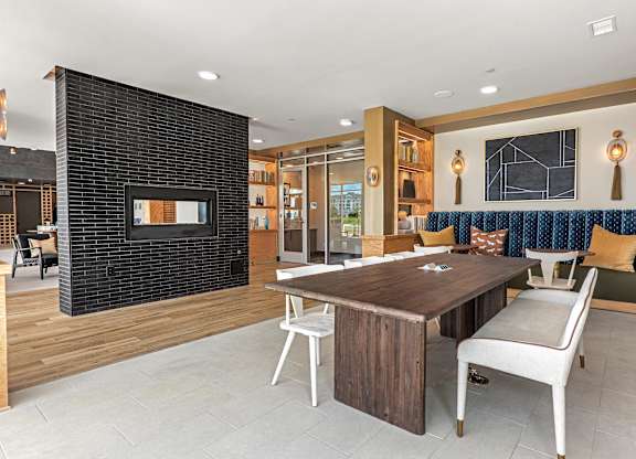 A modern living room with a fireplace and a dining table.