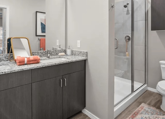 A bathroom with a sink, mirror, and towel.