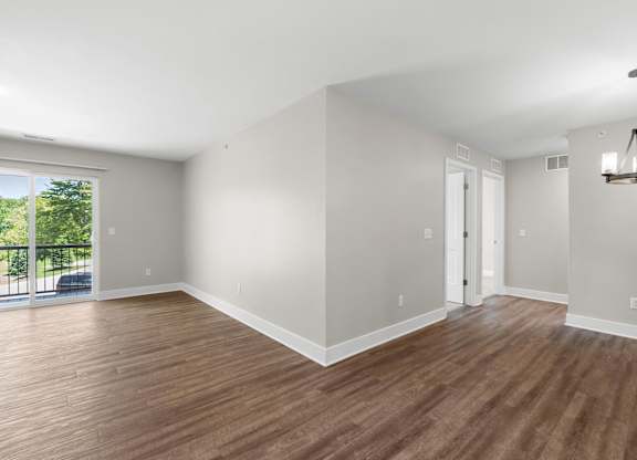 A room with wooden floors and white walls.