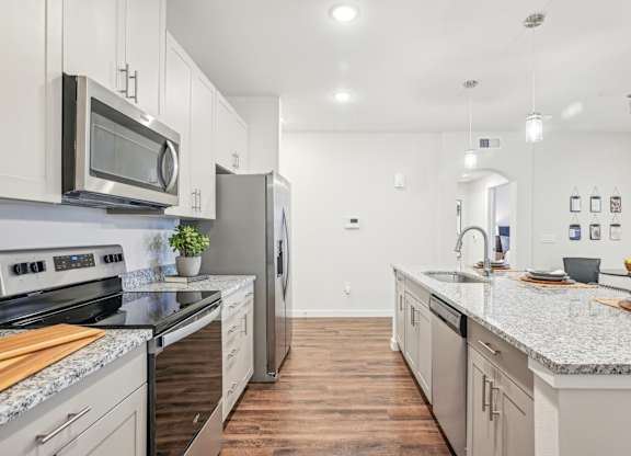 A kitchen with a stove top oven and a microwave above it.