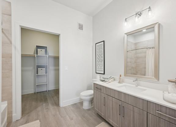 A bathroom with a toilet, sink, and medicine cabinet.