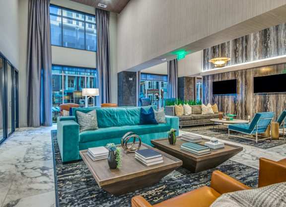 A modern living room with a blue couch and a coffee table.