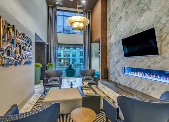 A modern living room with a television and a fireplace.
