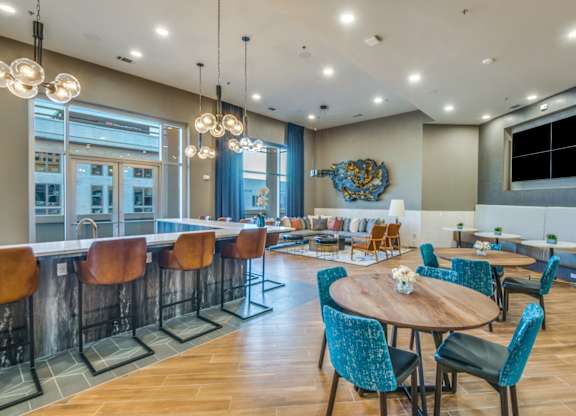 A modern dining area with a wooden table surrounded by chairs.