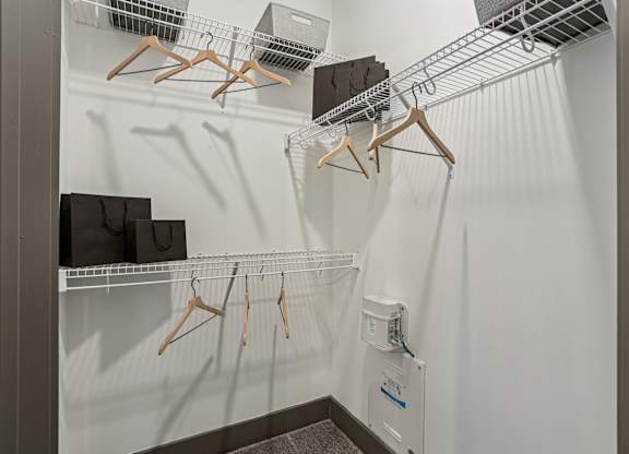 Closet with hangers and shelves.