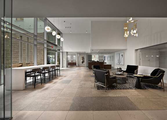 a large lobby with chairs and tables and a bar