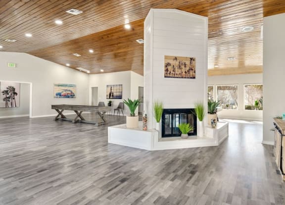 a living room with a fireplace and a wooden ceiling