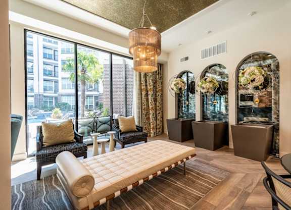 A living room with a large window and a view of a cityscape.