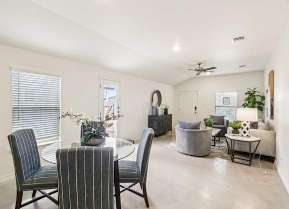 A dining room with a table and chairs.