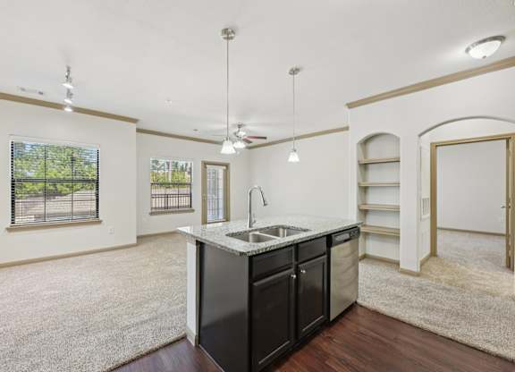 A kitchen with a sink and a refrigerator.