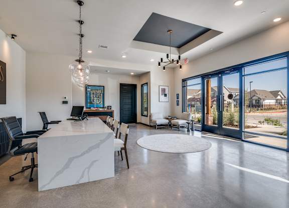 A modern home interior with a large kitchen island and dining area.