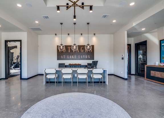 A modern dining room with a large table and chairs.