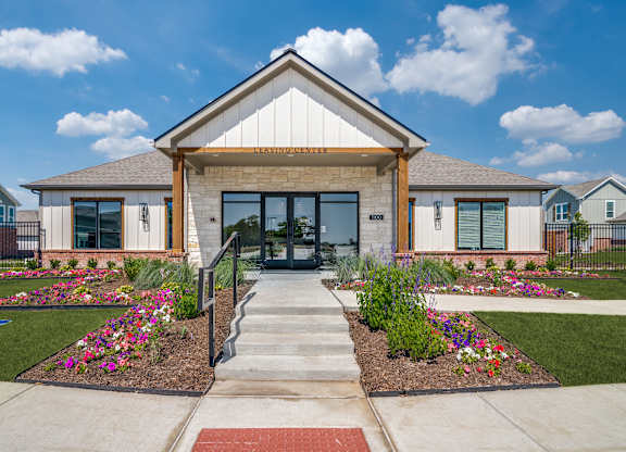 A building with a front yard and a sign that says "ENTRANCE".