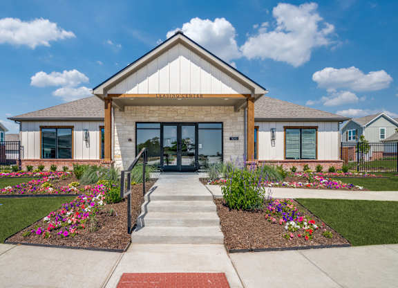 A building with a front yard and a sign that says "ENTRANCE".