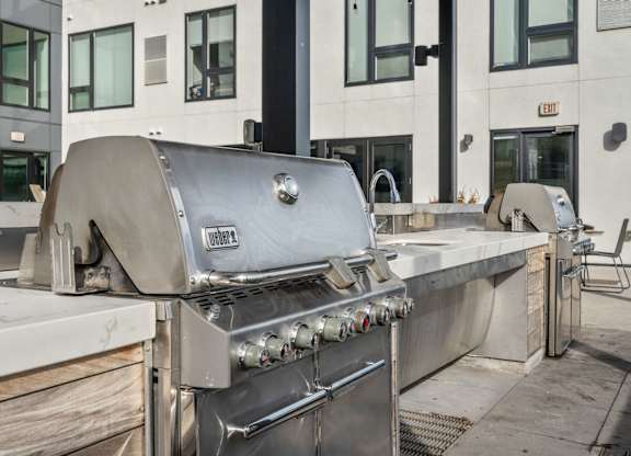 A large Volvo grill is on a patio.