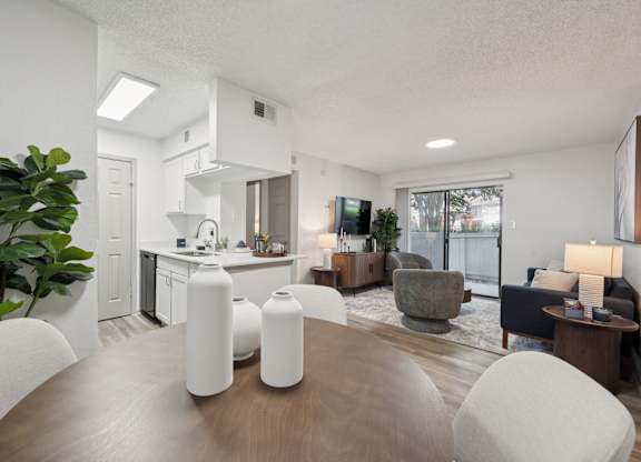 A modern kitchen with white vases on the table.