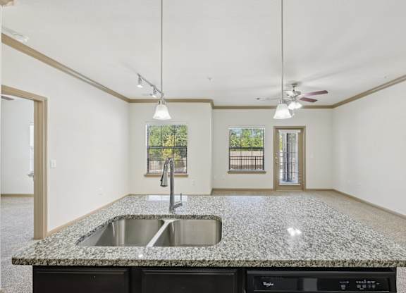 A kitchen with granite countertops and a sink.