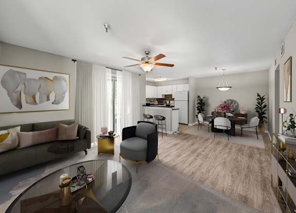 A modern living room with a glass coffee table and a grey sofa.